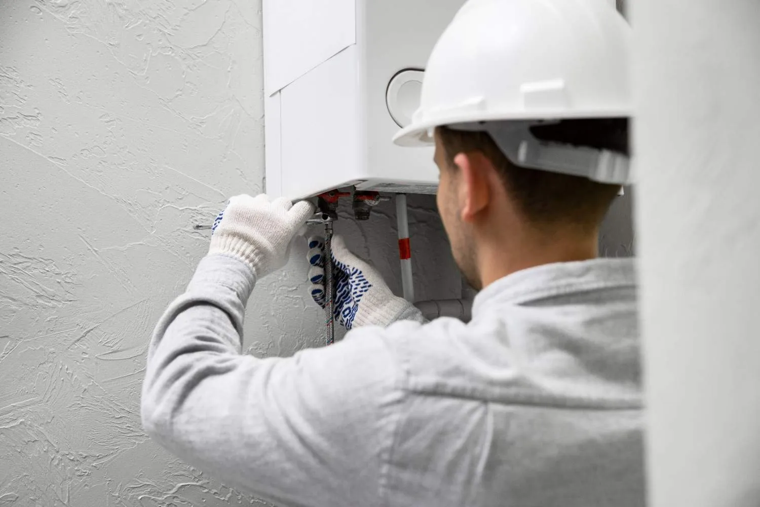 Technician checking a wall mounted water heater